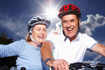 Buy stock photo Mature couple, helmet or bicycle for hobby with blue sky, portrait or smile for weekend exercise. Fitness, cardio or bike with safety hands for workout and health, cycling or married people for sport