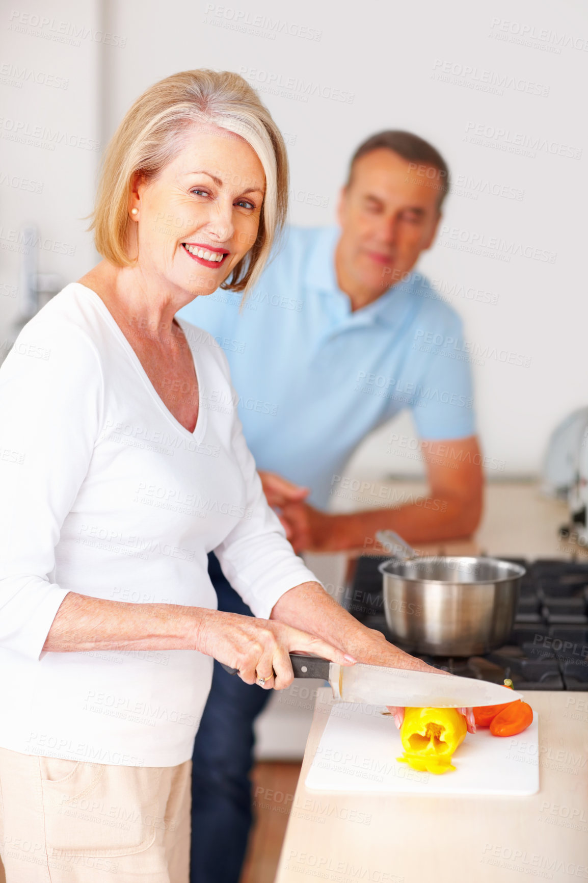 Buy stock photo Portrait, cooking and woman cutting peppers in kitchen for nutrition dinner or meal for date with husband. Smile, food and mature female person chop ingredient for healthy or diet supper at home.