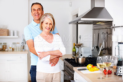 Buy stock photo Senior couple, happy and portrait in kitchen for snack, lunch and nutrition as romantic partner in love. Woman, man and retirement in bonding, relationship or together in home for hug, health or care