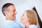 Cheerful senior man and woman looking at each other