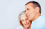 Loving senior couple against white background - copyspace