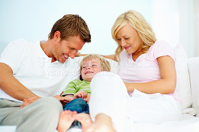 Buy stock photo Mother, father and smile with boy on sofa for love, care and bonding together in family home. Happy mom, dad and kid relaxing on couch for childhood support, playing and development in living room 