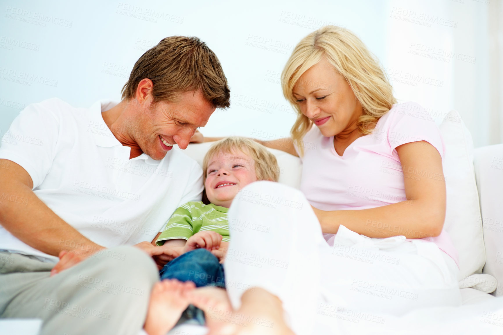 Buy stock photo Mother, father and smile with boy on sofa for love, care and bonding together in family home. Happy mom, dad and kid relaxing on couch for childhood support, playing and development in living room 