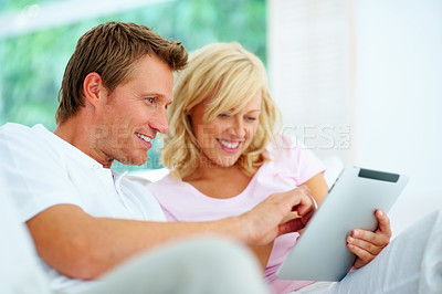 Buy stock photo Couple, tablet and happy in home to scroll social network, download ebook app and streaming multimedia subscription. Man, woman and smile for digital blog, online shopping or search website in lounge