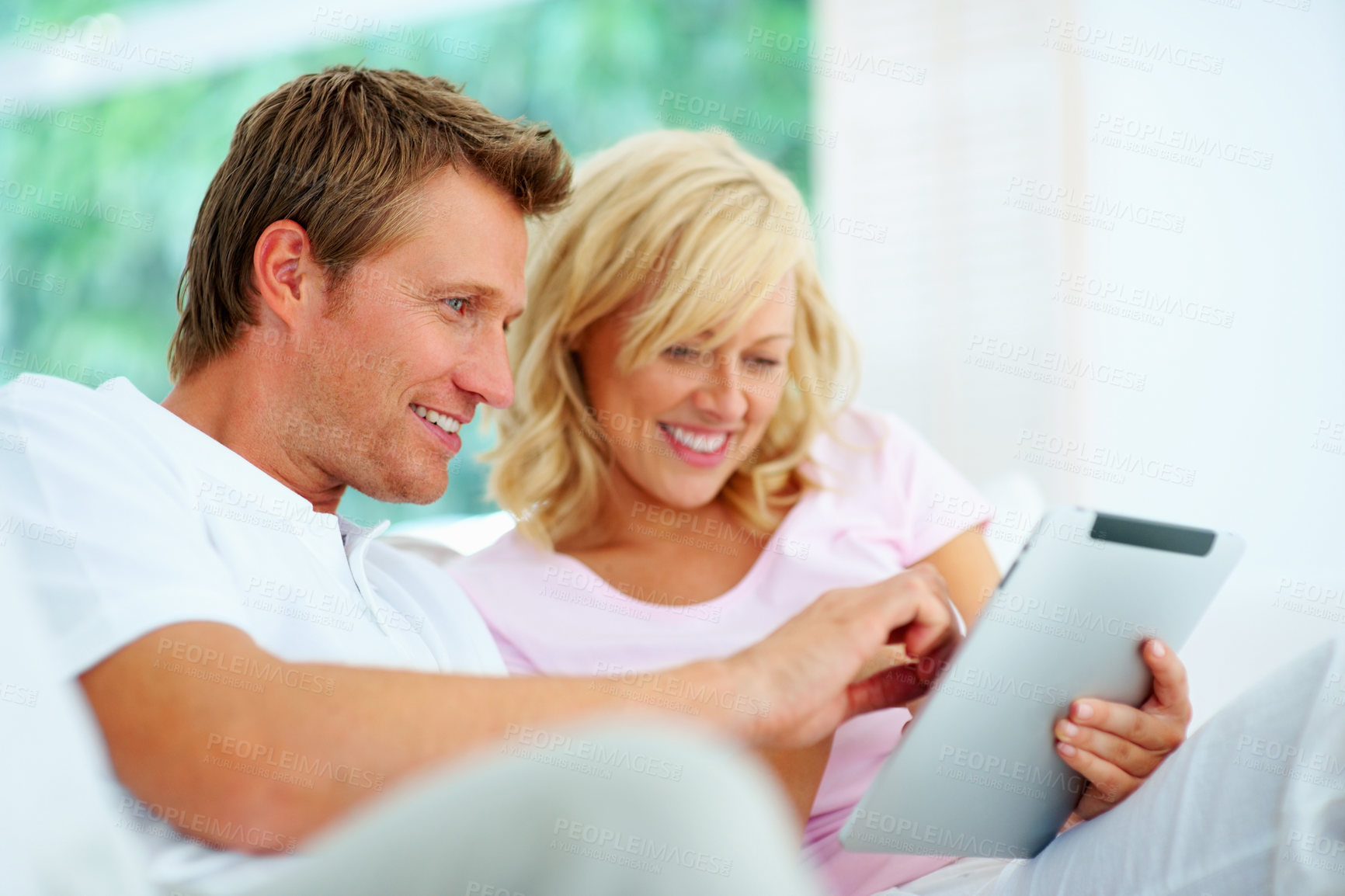 Buy stock photo Couple, tablet and happy in home to scroll social network, download ebook app and streaming multimedia subscription. Man, woman and smile for digital blog, online shopping or search website in lounge