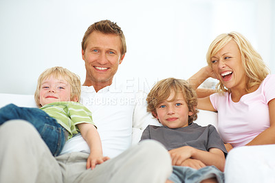 Buy stock photo Mother, father and portrait with children on sofa for love, care or bonding together in family home. Happy mom, dad and boy kids relaxing on couch for support, security and development in living room