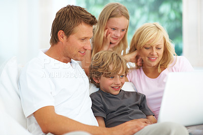 Buy stock photo Laptop, video or streaming with a family on a sofa in the living room of their home together for entertainment. Parents, children or computer for subscription service with a mother, father and kids