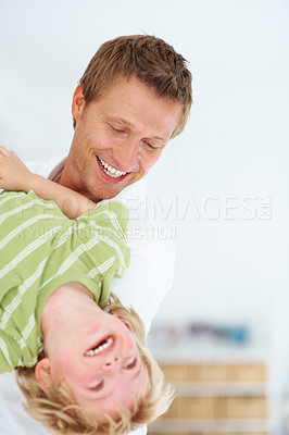 Buy stock photo Smile, fun and father playing with child at home for bonding time together with mockup space. Happy, positive and dad with young boy kid from Australia with energy for care and love in family house.