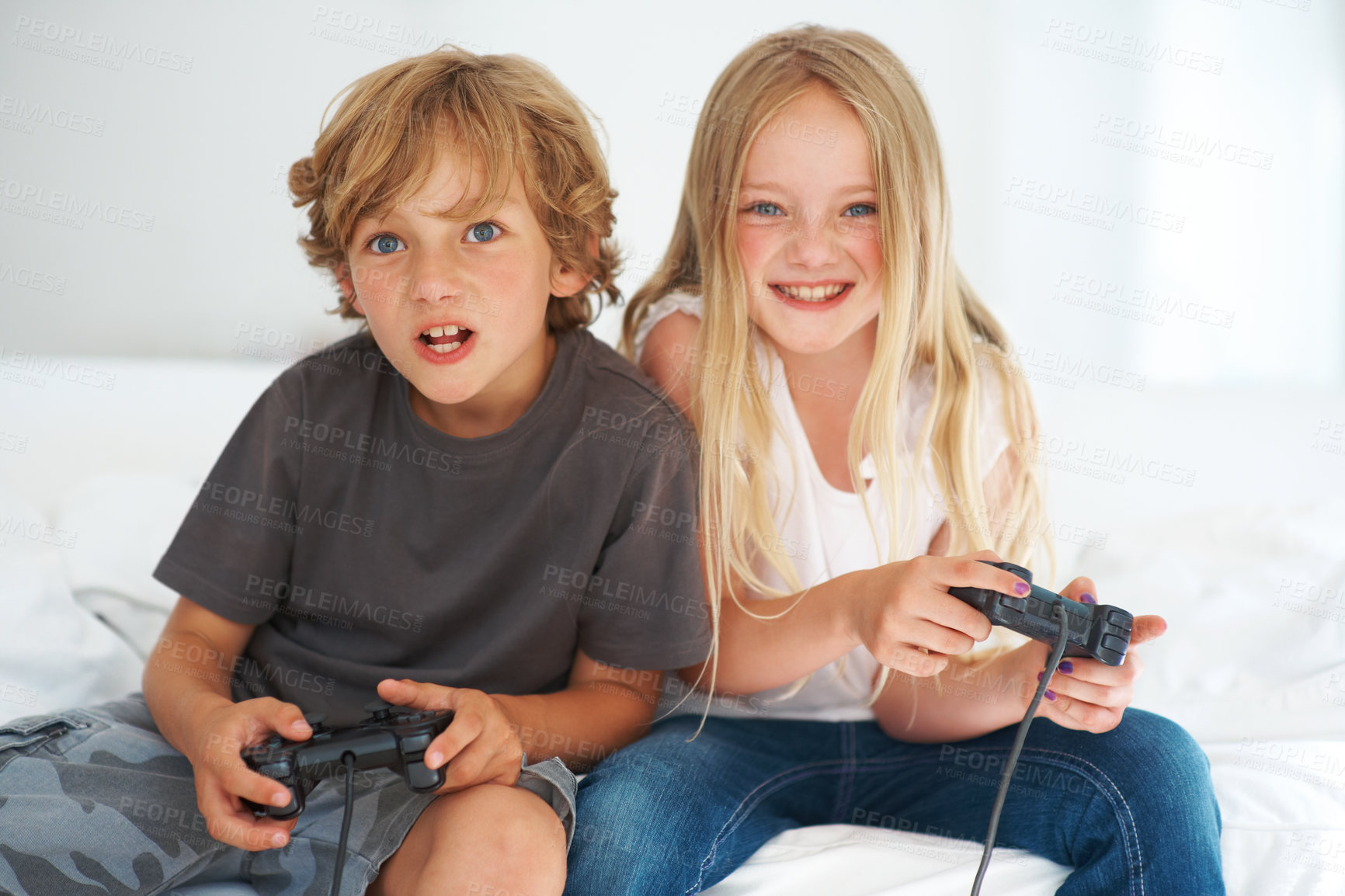 Buy stock photo Happy, children playing video game on sofa and portrait  together in home living room for competition. Kids smile,  brother and sister on controller, family entertainment and sibling rivalry in house