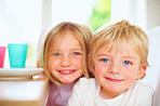 Cute young boy with his sweet sister, smiling