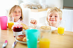 Brother and sister having their breakfast together