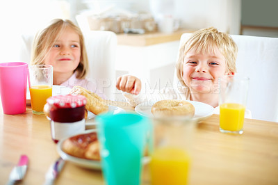 Buy stock photo Smile, kitchen and children eating breakfast together for healthy, wellness and diet meal. Happy, laughing and kid siblings bonding and enjoying lunch or brunch with juice at table in family home.