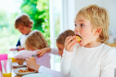 Buy stock photo Kid, breakfast and eating food with family in home, healthy diet and nutrition in the morning. Hungry, mouth and young children with meal at table for pastry dessert with siblings together in house