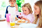 Pretty little girl with her family removing jam from bottle