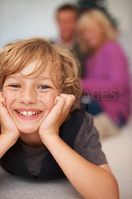 Buy stock photo Portrait, boy and relaxing with parents for holiday, happy and excited on floor. Bonding together, smile and family home for festive season, cheerful and joy in house, childhood memories or indoor
