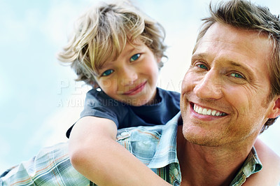 Buy stock photo Father, son and portrait or happy with piggyback for bonding, relationship and freedom with blue sky in nature. Family, man and boy child with playing, care and love for excitement, peace and support