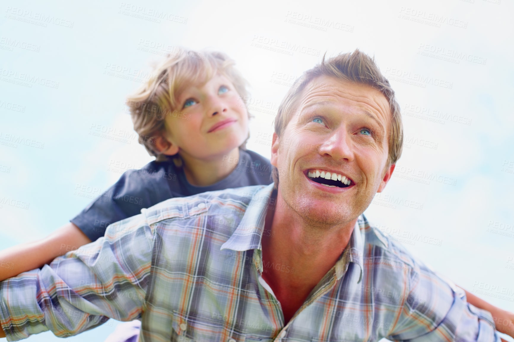 Buy stock photo Father, son and smile outdoor with piggyback for bonding, relationship and freedom with blue sky in nature. Family, man and boy child with playing, care and love for excitement, peace and support