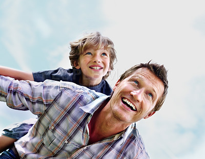 Buy stock photo Father, son and smile outdoor with piggyback for bonding, relationship and freedom with blue sky in nature. Family, man and boy child with playing, care and love for happiness, peace and support