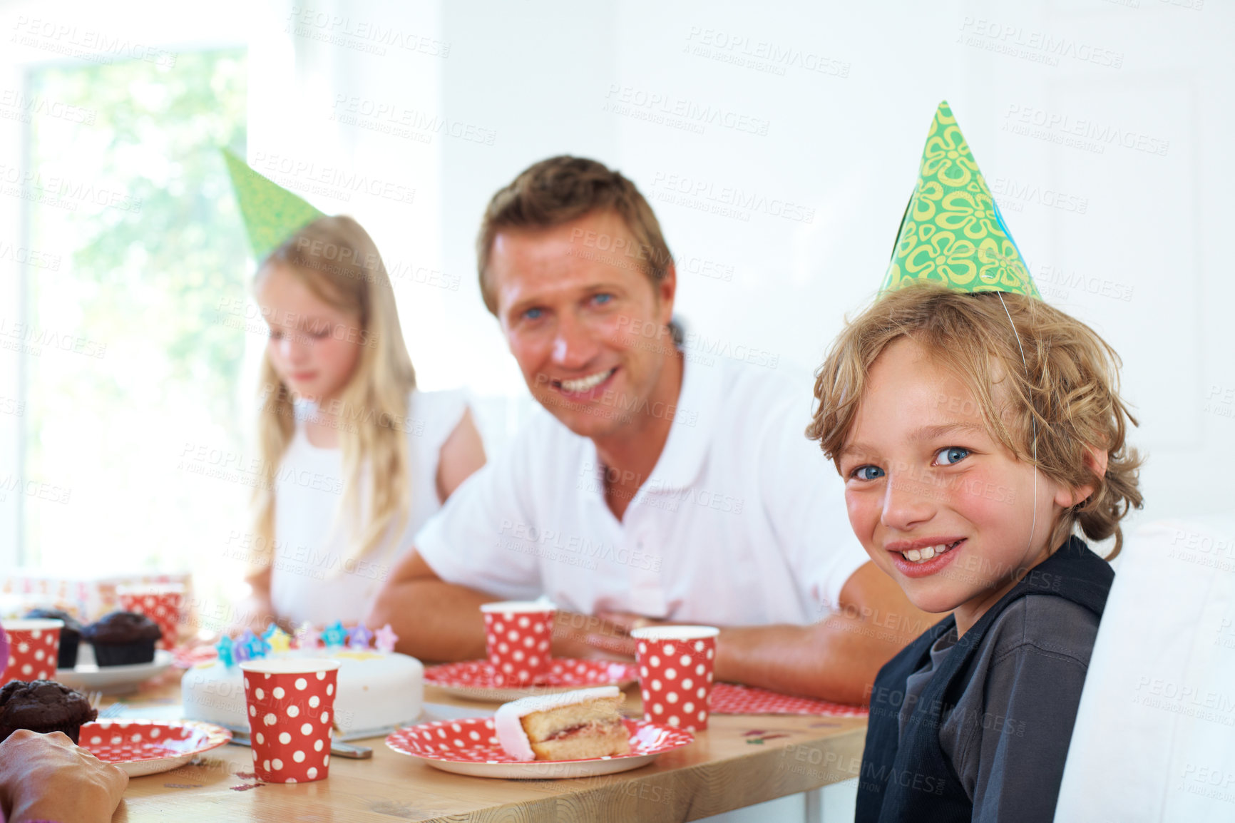 Buy stock photo Young boy, father or portrait at birthday celebration with fun, party hats or home on weekend. Cute kid, smile face or happy man by table with cake or excited family for special event in living room