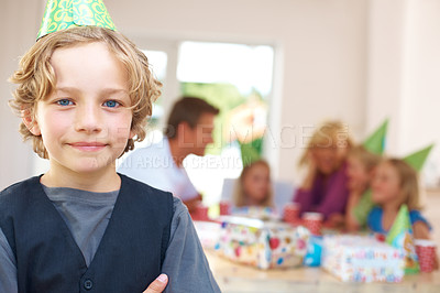 Buy stock photo Boy, portrait and happy at party hat, birthday celebration and fun in home on weekend. Cute kid, smile face and positive with casual clothes and excited family for special event in living room