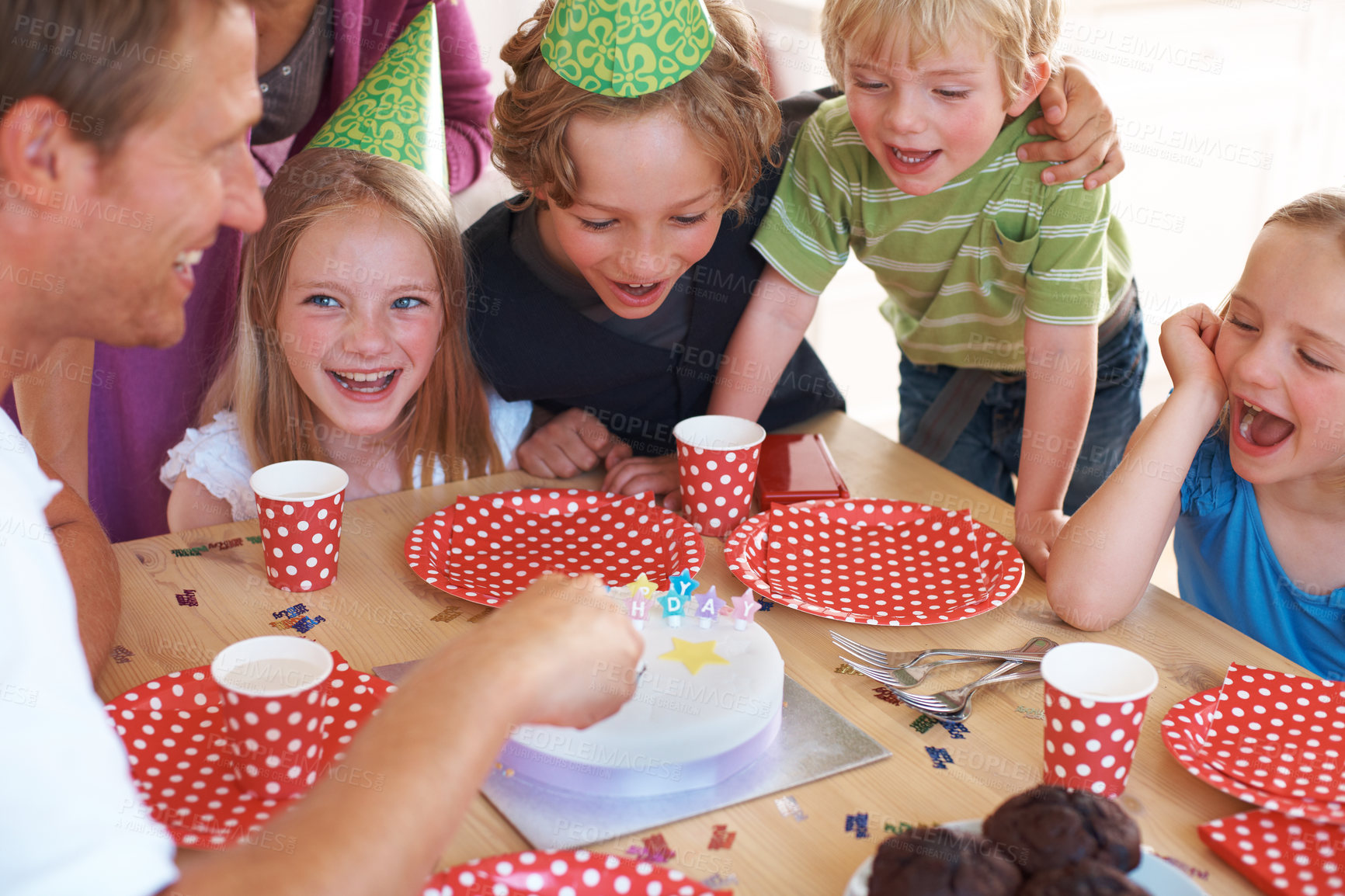 Buy stock photo Happy birthday, cake decoration and celebration by table, party and fun in home with wellness. Father, children and excited family by muffins, candles and hats with love for special event in house