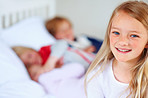 Smiling little girl with his family in blur background