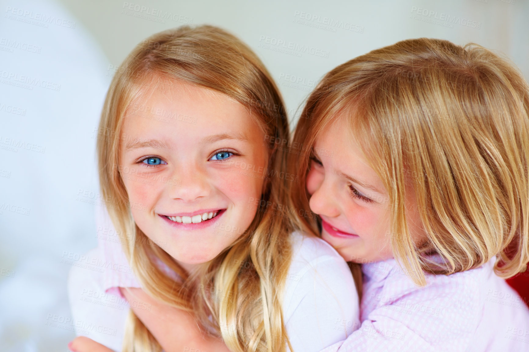 Buy stock photo Portrait, girl and hug indoors with love for relax wellness, happiness and siblings support in home. Children, embrace and smile face for respect in unity, adore and family bonding for care in house