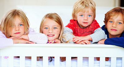 Buy stock photo Portrait, smile or love with boy and girl sibling children on a bed in their home together. Family, happy or bonding with young brother and sister kids in the bedroom of an apartment on the weekend