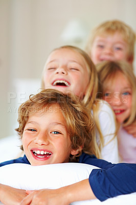 Buy stock photo Portrait, love or laughing with brother and sister sibling children on a bed in the home together. Family, happy or bonding with funny boy and girl kids in the bedroom of an apartment on the weekend