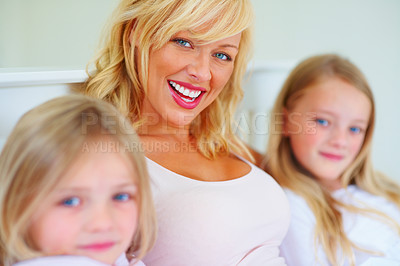 Buy stock photo Happy, portrait and mother with children on bed for bonding, relaxing and spending time together. Smile, love and young mom chilling and resting with girl kids from Australia in bedroom of house.