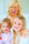 Cheerful little girl together with her sister and mother