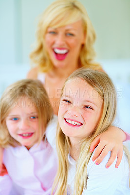 Buy stock photo Love, portrait and mother with children on bed for bonding, relaxing and spending time together. Smile, happy and young mom chilling and resting with girl kids from Australia in bedroom of house.