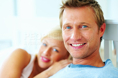 Buy stock photo Portrait, couple and face of man in bed of home for love, care and relax on holiday, rest or wake up together. Happy guy bonding with woman in relationship, freedom or romantic anniversary in morning