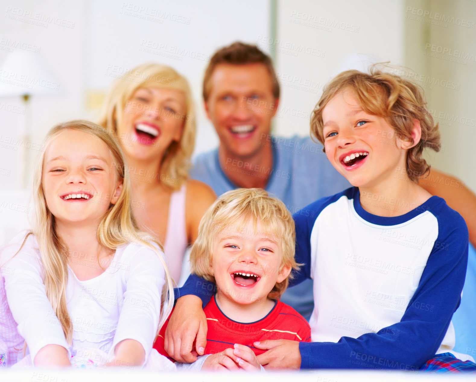 Buy stock photo Happy, portrait and parents with children on bed for bonding, relaxing and spending time together. Smile, love and young mother and father resting with kids from Australia in bedroom at family home.