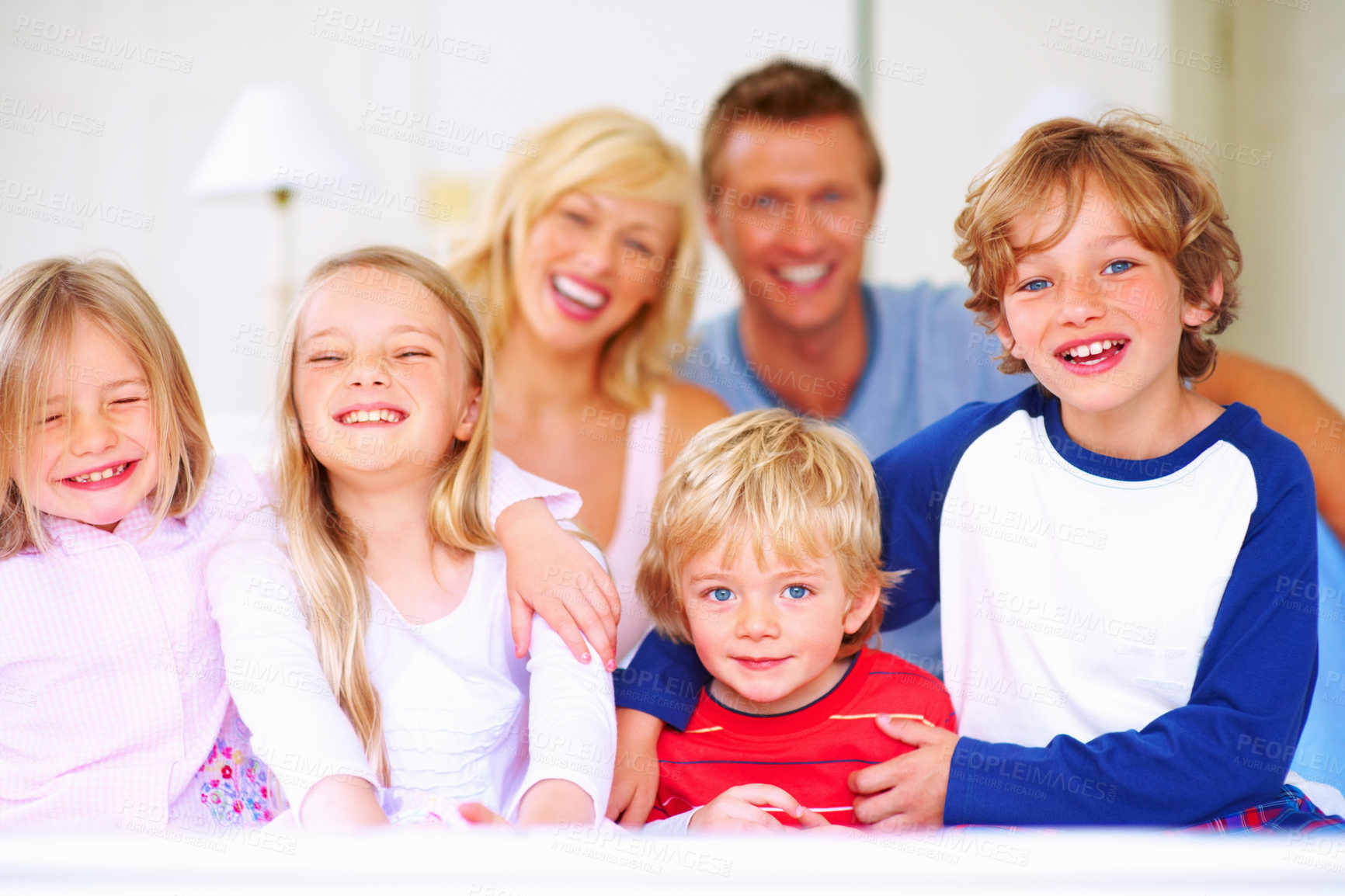 Buy stock photo Smile, portrait and parents with children on bed for bonding, relaxing and spending time together. Happy, love and young mother and father resting with kids from Australia in bedroom at family home.