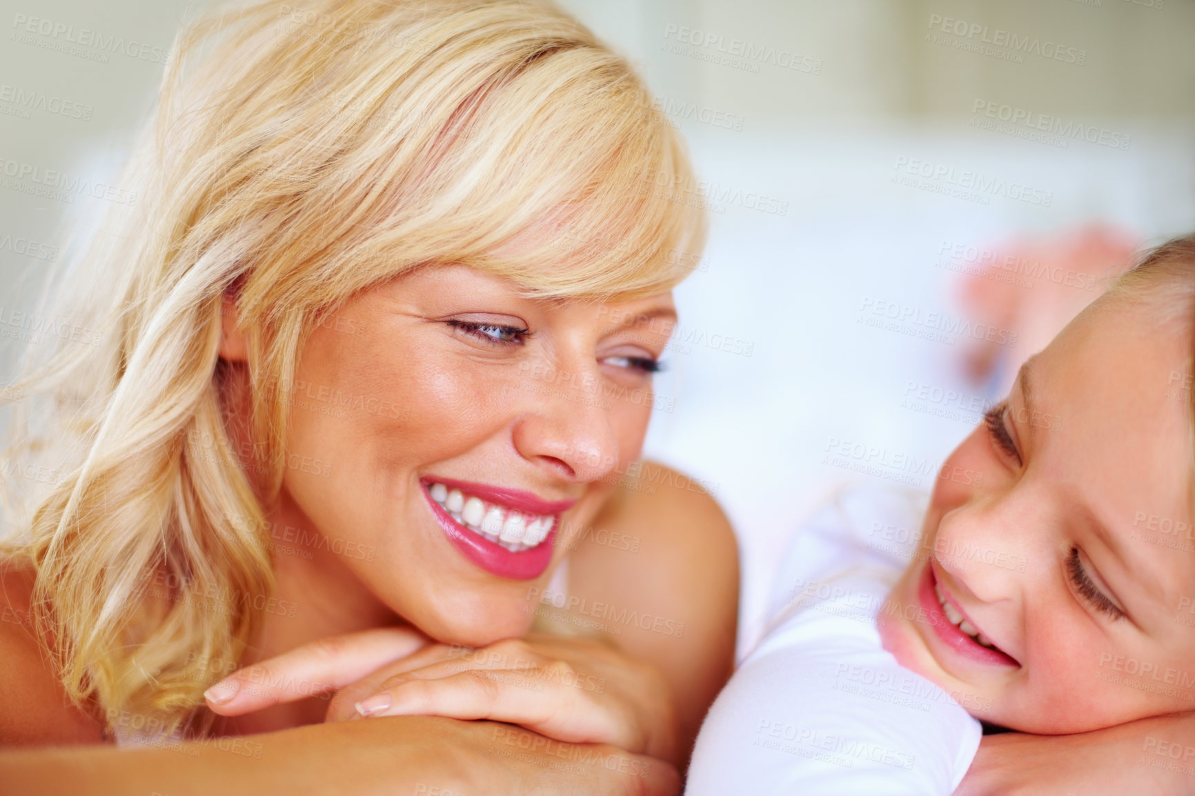 Buy stock photo Happy, conversation and mother with child on bed for bonding, relaxing and spending time together. Smile, love and young mom chilling and resting with girl kid from Australia in bedroom of house.