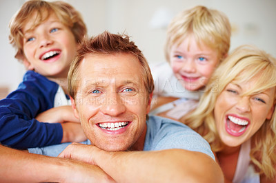 Buy stock photo Portrait, smile and a crazy family on a bed together while in their home on a weekend morning. Face, love or funny with a father, mother and kids in the bedroom of an apartment to relax for bonding