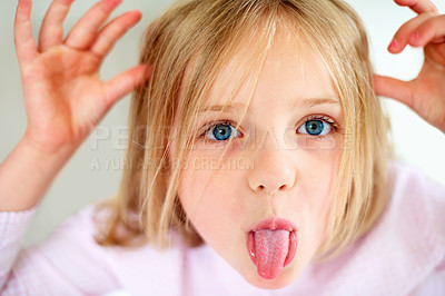 Buy stock photo Silly, tongue out and portrait of child in home with funny, comic and humor facial expression. Childhood, crazy and closeup of young girl with hand gesture for goofy face, playful joke and emoji