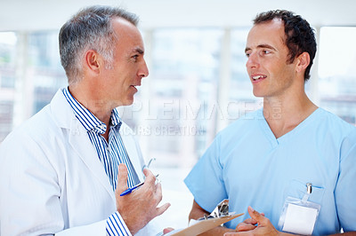 Buy stock photo Healthcare, doctor and nurse with a clipboard, advice and communication with test results, career and wellness. Staff, medical and professional with documents, conversation or talking with physician 