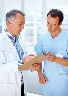 Buy stock photo Healthcare, doctor and nurse with a clipboard, conversation and communication with test results, sign and wellness. Staff, medical and professional with documents, career and talking with physician 