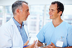 Doctor discussing chart with male nurse