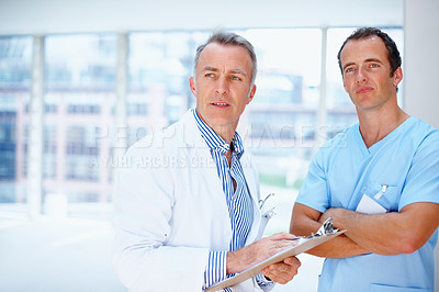 Buy stock photo Doctors, men and clipboard in hospital together for thinking, space and vision for medical info. Medic team, partnership and checklist for wellness, healthcare or idea for problem solving at clinic