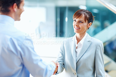 Buy stock photo Happy business people, handshake and meeting for partnership, b2b or corporate deal at office. Businessman and woman shaking hands in greeting, introduction or company agreement together at workplace