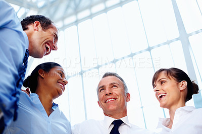 Buy stock photo Hug, business people and smile with support, startup and conversation with cooperation, collaboration and partnership. Group, team building and staff with low angle, embrace and company development