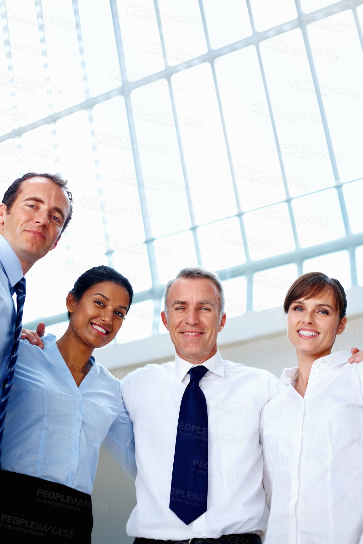 Buy stock photo Businesspeople, portrait and smile with low angle in office with hug, embrace and unity for diversity in community. Team, man and women by together for corporate, collaboration or global partnership 