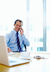 Businessman smiling while talking on cell phone
