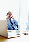 Executive smiling during discussion on phone