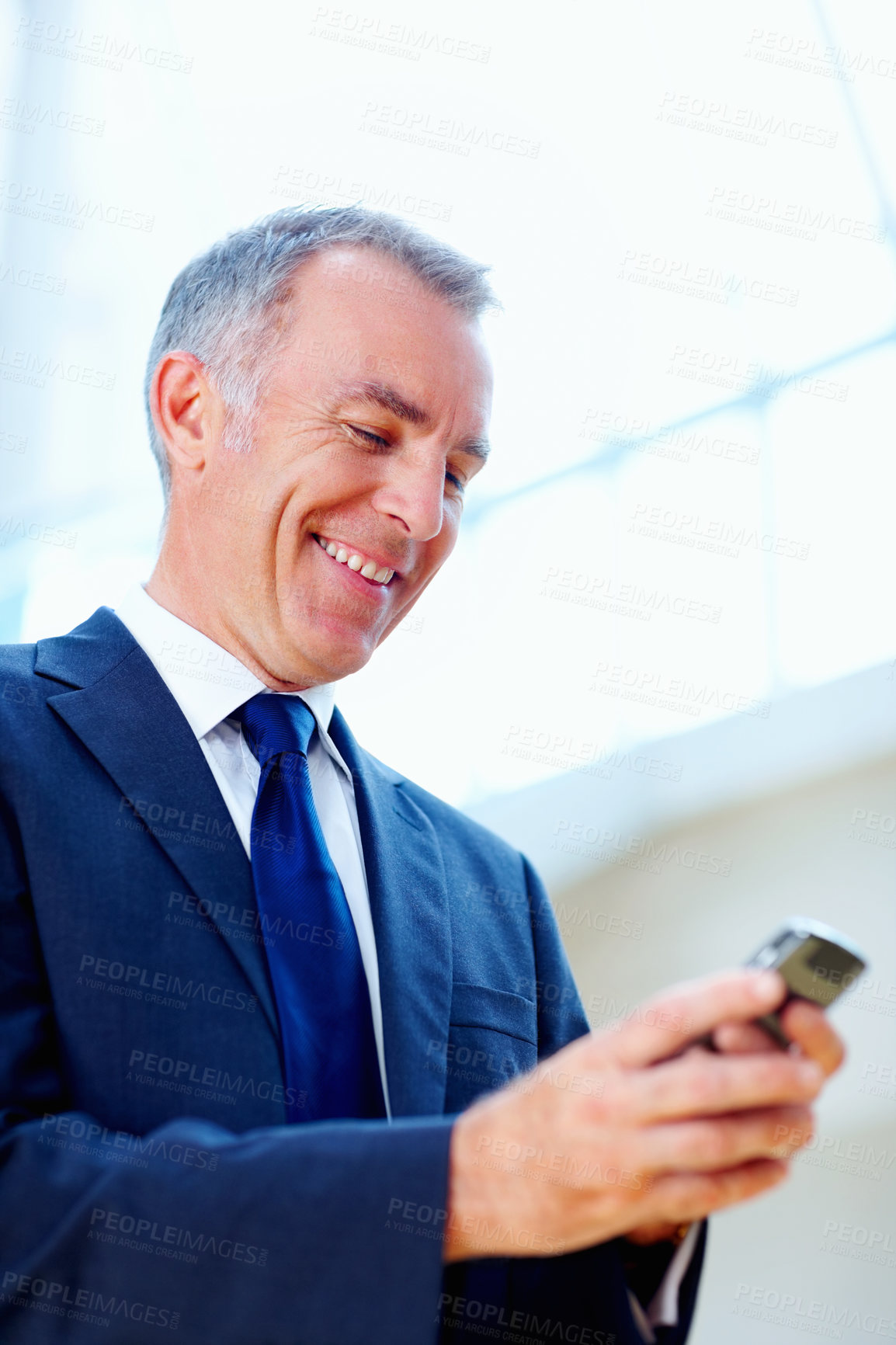 Buy stock photo Mature CEO, businessman and happy with phone for text message, notification and typing feedback email at work. Professional, boss and person with technology for networking, communication and smile