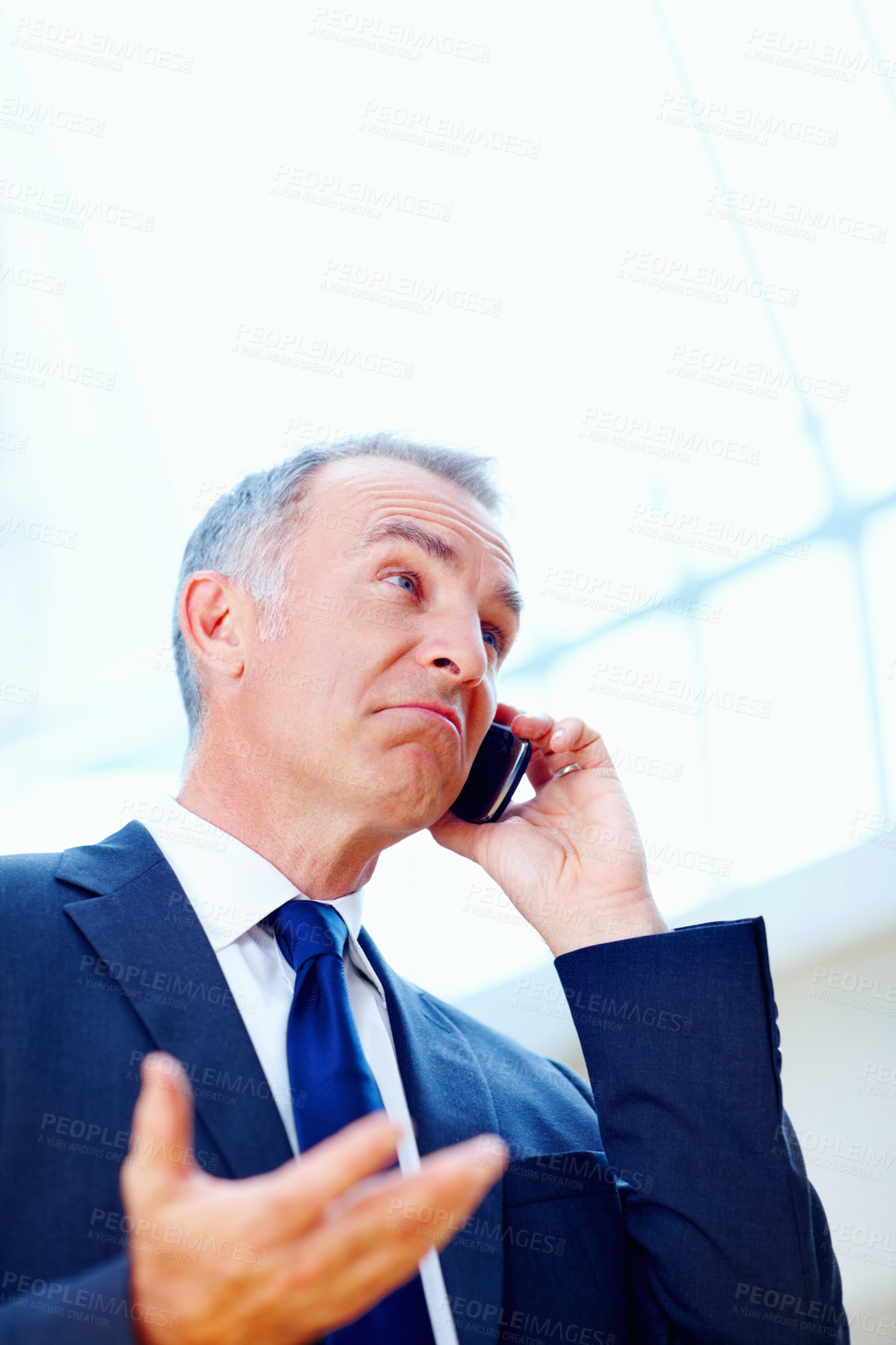 Buy stock photo Senior executive with puzzled look while on cell phone