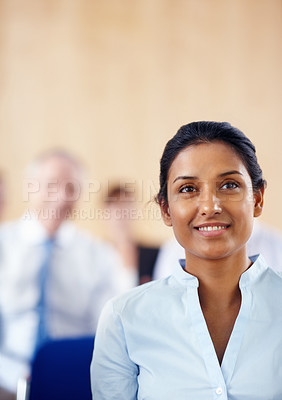 Buy stock photo Businesswoman, smile and listen to presentation at audience, conference or seminar in boardroom. Indian person, female manager and formal fashion with excitement for speaker, discussion or panel